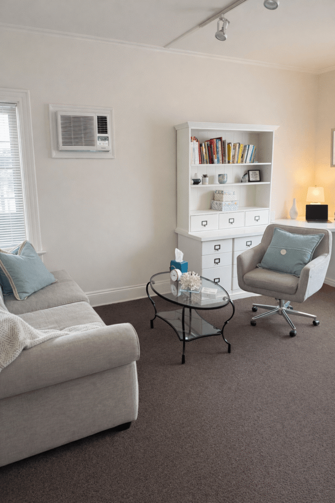 Office of Ever Rising LMHC showing a couch and a chair in a warm inviting room