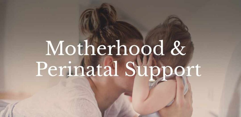 Mother holding and comforting a young child, representing support during motherhood and the perinatal period